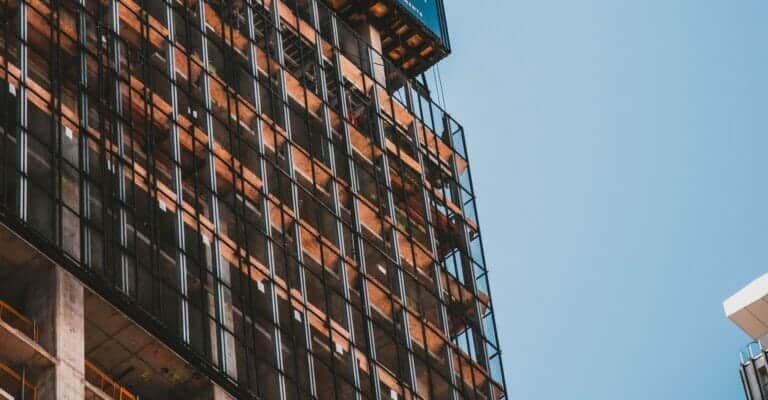 A commercial real estate building in progress with scaffolding that started with due diligence and feasibility services before being build.