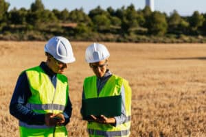 environmental site assessment concept: 2 surveyors reviewing the results in a field