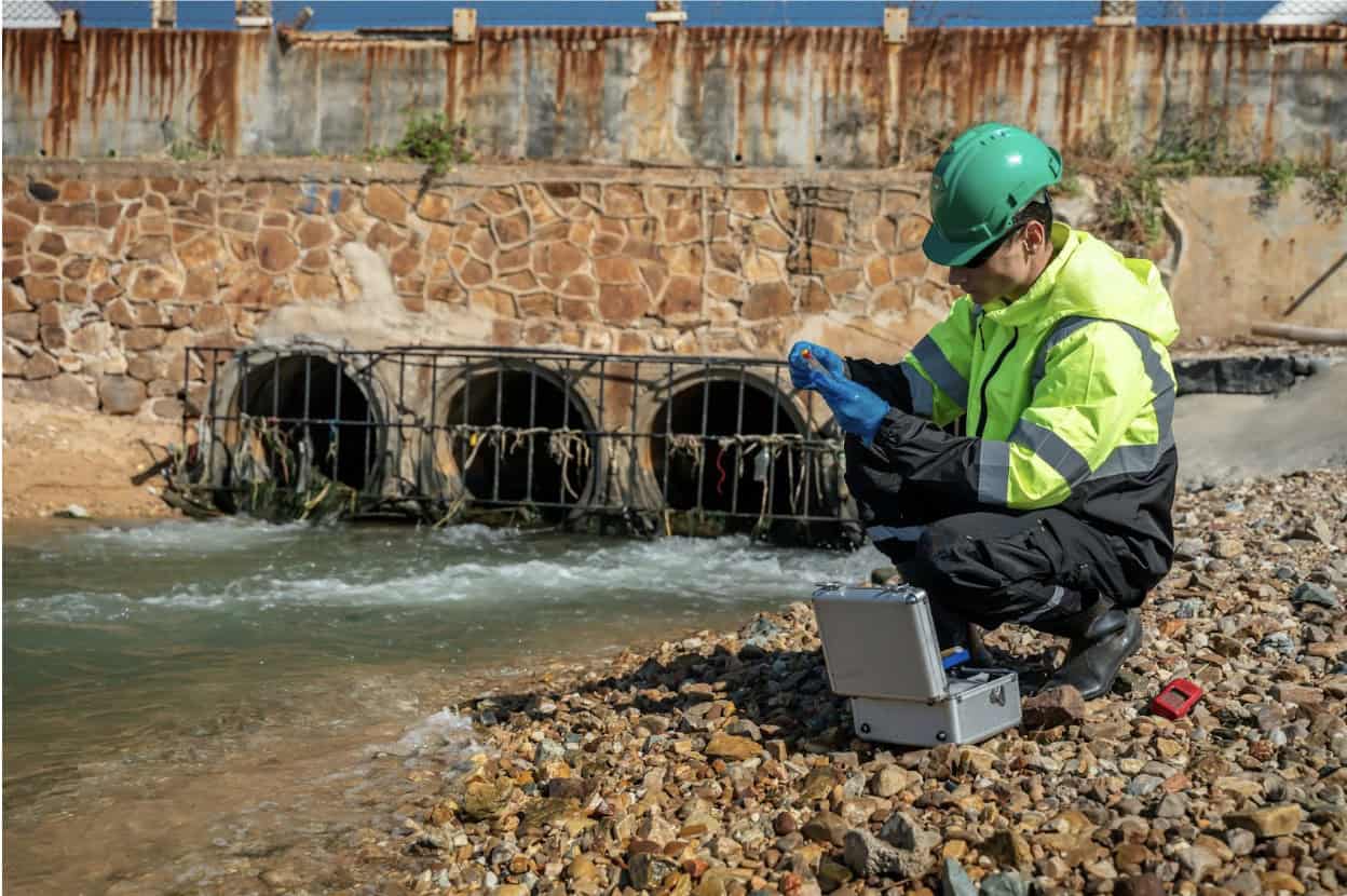 Engineer conducting water survey near stormwater drains