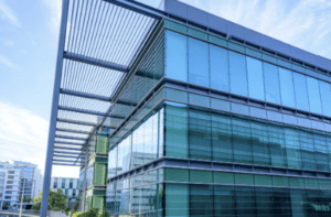 Modern data center facility exterior with glass architecture and utility infrastructure supporting high power capacity