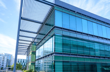 Modern data center facility exterior with glass architecture and utility infrastructure supporting high power capacity
