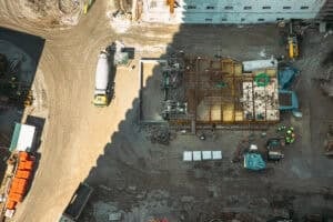 aerial view of active multistory residential construction site with concrete work and equipment