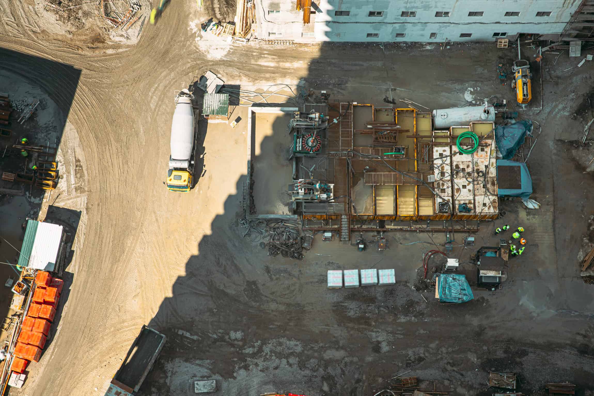aerial view of active multistory residential construction site with concrete work and equipment