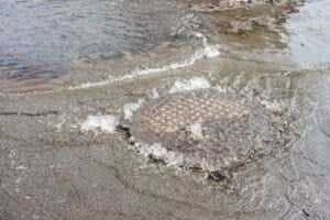 water flowing over manhole cover